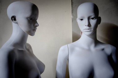 White scary mannequins stand and look at each other clipart