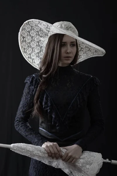 Girl Old Dress Hat Stands Dark Background Sad — Stock Photo, Image