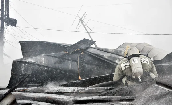 Los bomberos apagan la llama al fuego —  Fotos de Stock