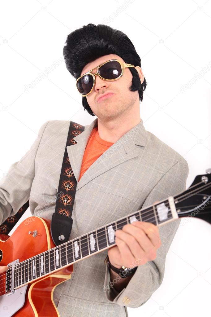 Elvis Presley plays guitar