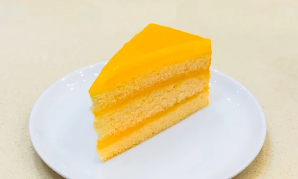 Fresh piece of orange cream cake — Stock Photo, Image