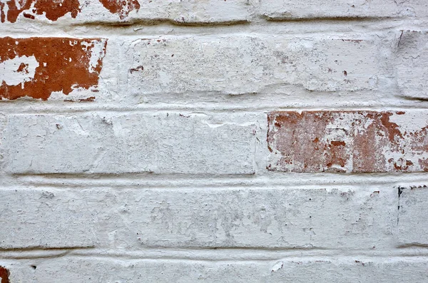 Red white wall background. Old grungy brick wall texture. Vintage wall with obsolete plaster