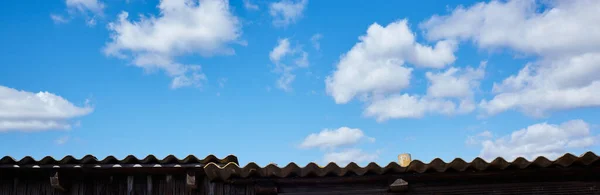Abstract image of blurred sky. Old roof against the blue sky background. For design, with a space for text