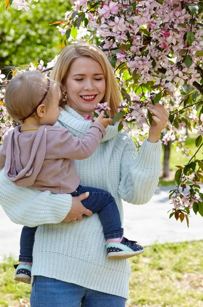 Mom and daughter on nature walk at spring park. Little girl and mother have a good time on weekend activity