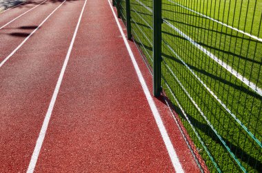 Spor sahasında kırmızı koşu bandı. Stadyumda koşu pisti