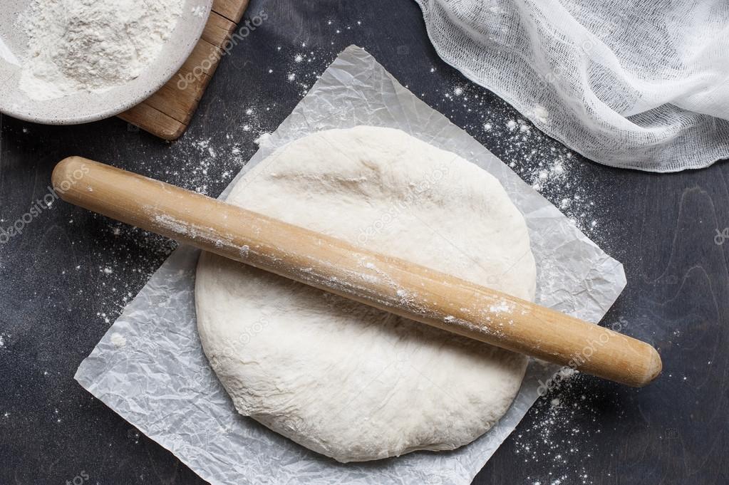 Roll out dough on table — Stock Photo © AlinaKho 79151448