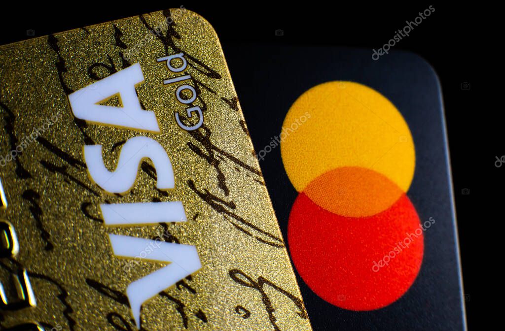 LVIV, UKRAINE - November 15, 2020 : Two credit cards on black background with VISA and MasterCard brand logos