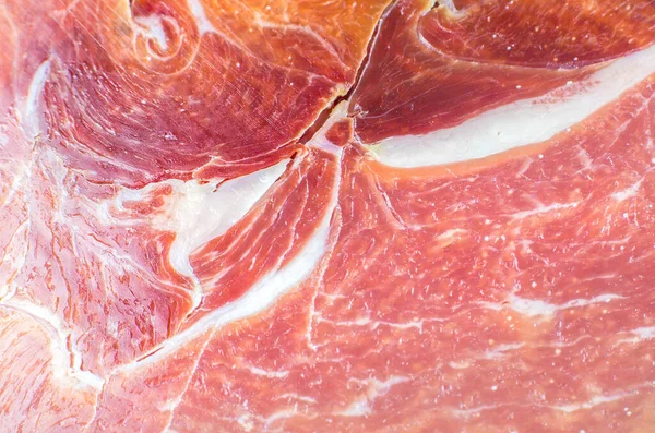 Red meat texture close up photo. Italian prosciutto crudo or jamon. Raw ham. Pork meat background.