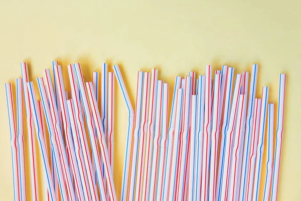 Plastic straws for cocktails. Pastel yellow colors. Summer vibes. Party with beverages.