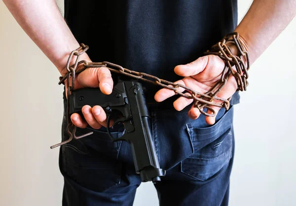古い錆びた鎖に銃を持った手 強盗は違法犯罪で逮捕された ムガーは法律を破った — ストック写真