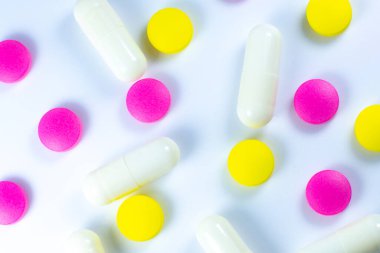 Beyaz arka planda renkli haplar. Kapatın. Tıbbi tedavi kavramı.