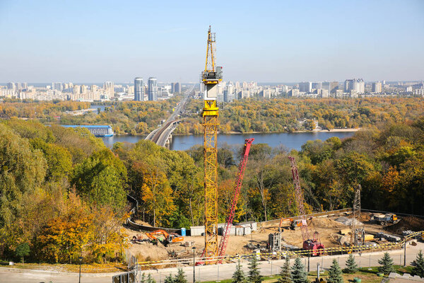 KYIV, UKRAINE - OCTOBER 12, 2019: View on construction building site. Autumn capital of Ukraine. City landscape with river Dnipro.