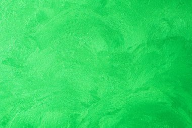 Dekoratif alçı. Yeşil duvar dokusu arka plan. Somut bir tarz. Kapalı alanda restorasyon. Bakım işleri.