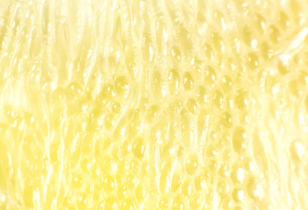 Beyaz arka planda greyfurt dokusu var. Citrus yakın çekim fotoğrafı. Sağlıklı bir yaşam tarzı fotoğrafı. Güzel duvar kağıdı. Vejetaryen ve vejetaryen kavramı. Doğadan gelen vitaminler.