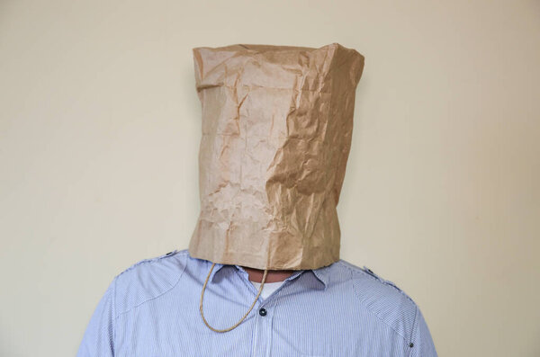 Kraft paper bag is on the man's head.