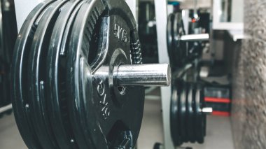 Spor salonundaki çiğ dambıllar. Fitness sporu motivasyonu. Sağlıklı yaşam tarzınız kutlu olsun. Çubuk ağırlıklarıyla egzersiz.