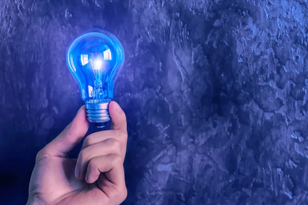 Man Holding Lamp Bulb New Idea Concept Blue Background — Stock Photo, Image