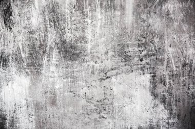 Yumuşak odaklı gri ve siyah duvar, arka planda çizikler var..