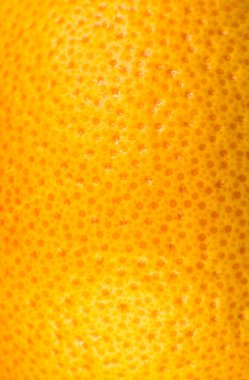 Greyfurt kabuğu dokusunun yakın fotoğrafını çek. Egzotik olgun meyve, turuncu arka plan, makro manzara. İnsan derisi sorunu kavramı, sivilce ve selülit. Güzel doğa duvar kağıdı.