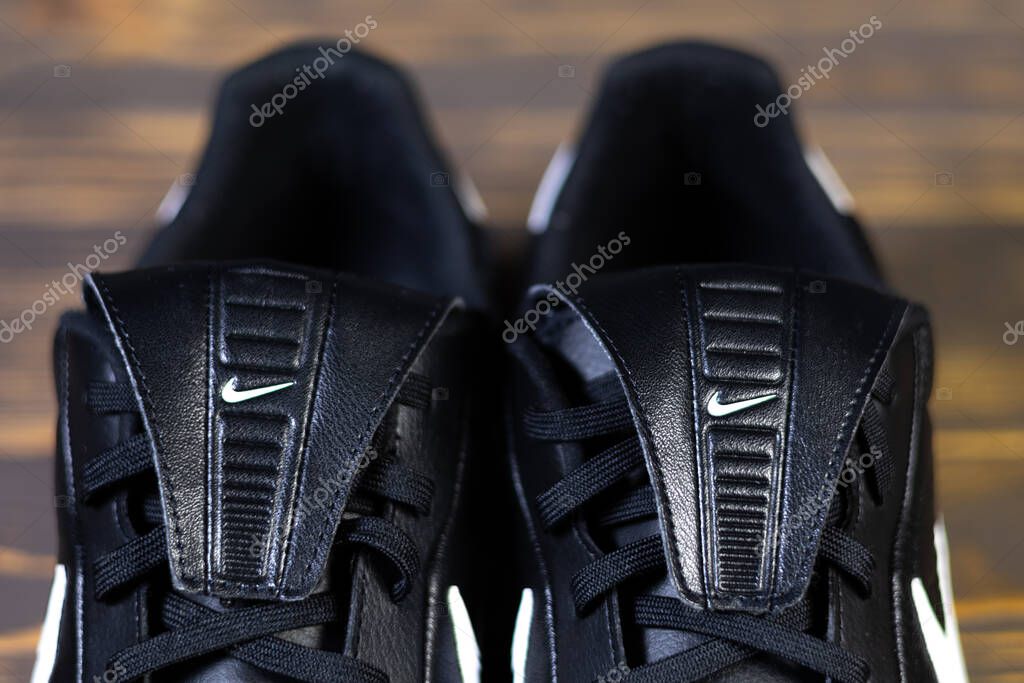 KYIV, UKRAINE - October 18, 2025 : Nike Premier III TF. Turf Low-Top Soccer Shoes. Black and white leather boots. Close up Nike company logo.