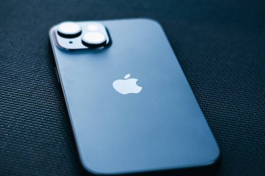 KYIV, UKRAINE - September 26, 2025 : Modern smartphone Apple iPhone on black textured background.