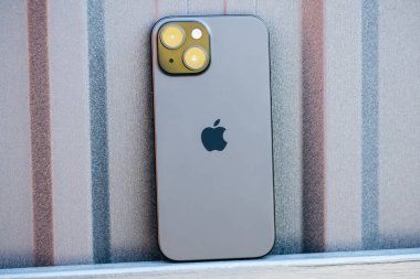 KYIV, UKRAINE - September 26, 2025 : Modern smartphone Apple iPhone on black iron background.