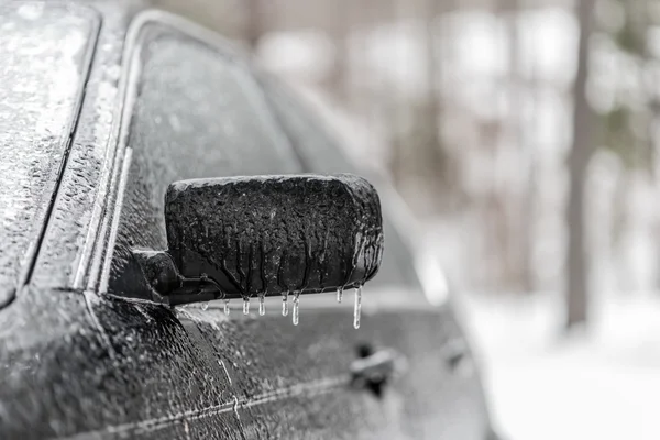 Freezing rain ice coated car.  Black vehicle car covered in freezing rain, Icicles hanging from side mirror.  bad driving weather in freezing rain. — Stock Photo, Image