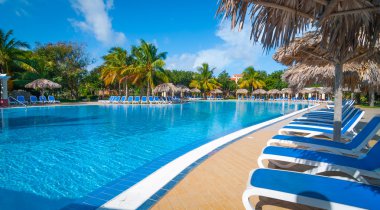 Beautiful blue sky holiday in Cuba.  View from pool,  getaway vacation in Varadero. clipart
