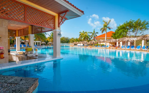 Drinks in the pool.  Beautiful blue sky holiday resort pool side view.  Getaway vacation in Varadero Cuba.