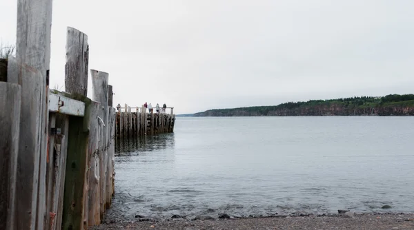 People fishing at the end of a dock in Springtime. Nova Scotia coastline in June. — Stock Photo, Image