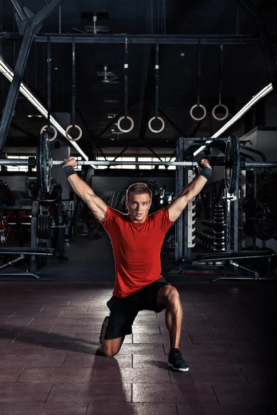 Young man  with barbell in gym — Stock Photo, Image