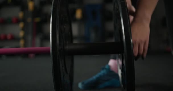 体育館でバーベルを準備するスポーツ女性 — ストック動画