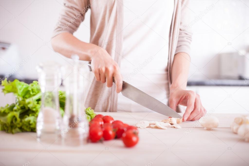 Woman cutting mushrooms 