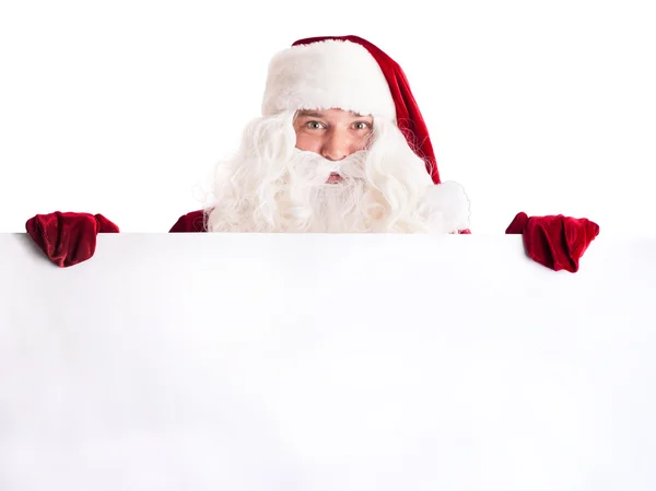 Weihnachtsmann zeigt auf weißes Blanko-Schild — Stockfoto