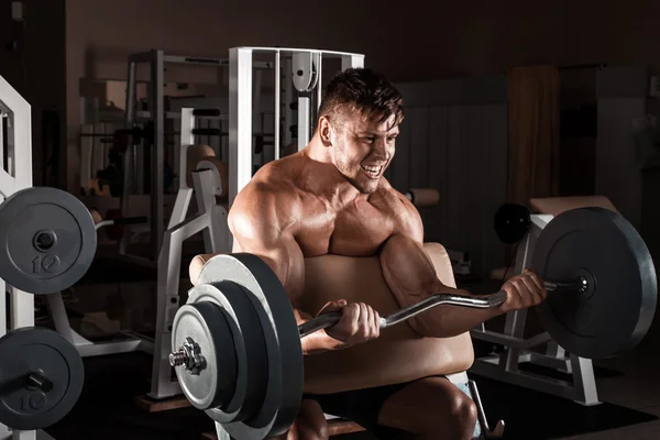 Muscular man workout with barbell — Stock Photo, Image