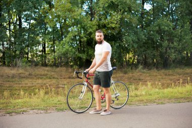 Genç hippi tarzı adam bisiklet ile poz