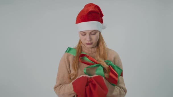Kerstman meisje in nieuwjaarspak met een rode zak. Wens en vakantie concept. — Stockvideo