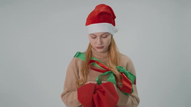 Девчонка Санта Клаус в рождественском наряде с красным мешком. Концепция пожеланий и праздников. — стоковое видео