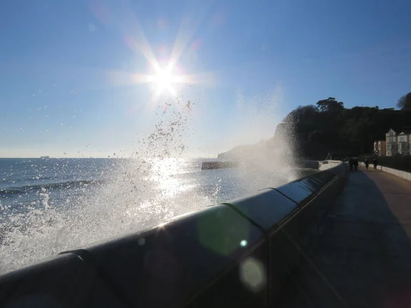 Sea Wall Dawlish looking out at sea in the sun. High quality photo