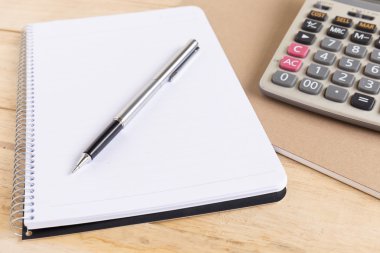 Boş beyaz defter kalem ahşap masa ile