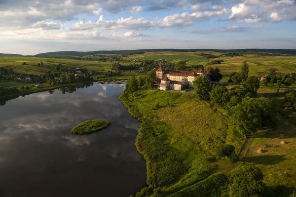 Vista aérea do campo no castelo velho com telhado vermelho sobre o lago — Fotografia de Stock