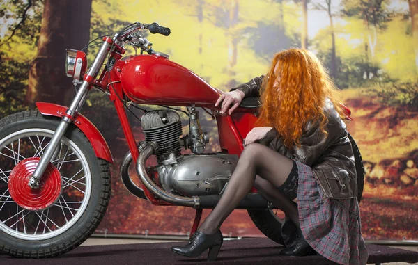 Redhad girl on motorbike Stock Image