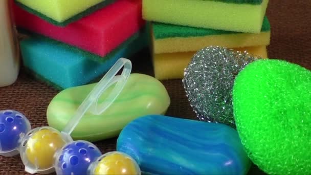 Container with liquid for glass, soap, colorful sponges for washing — Stock Video