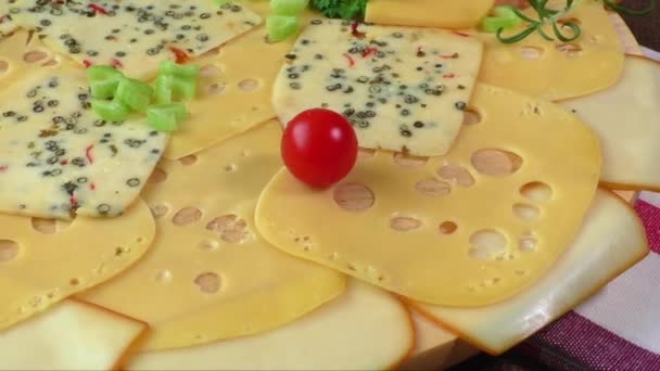 Variety of cheeses on a wooden board — Stock Video