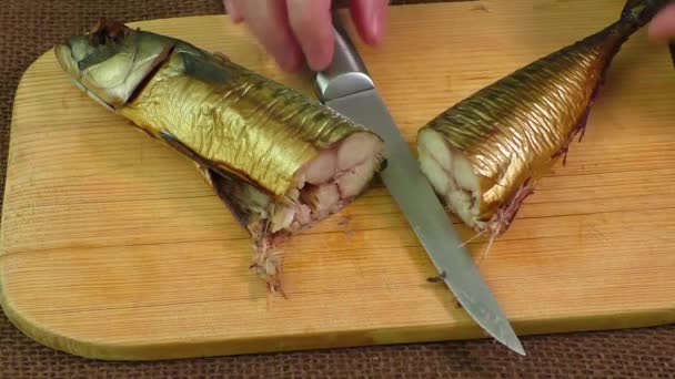 Smoked mackerel on a wooden cutting board — Stock Video