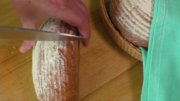 Woman slicing loaf of fresh bread — Stock Video