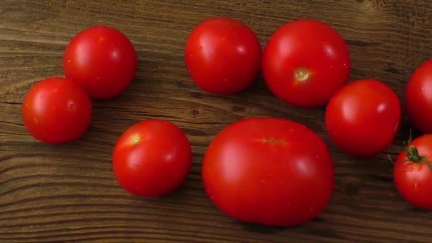 Red tomatoes on old wooden table — Stock Video