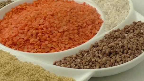 Collection of various legumes on a round white plate — Stock Video