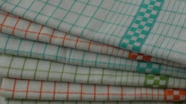 Colorful dish towels on wooden table — Stock Video