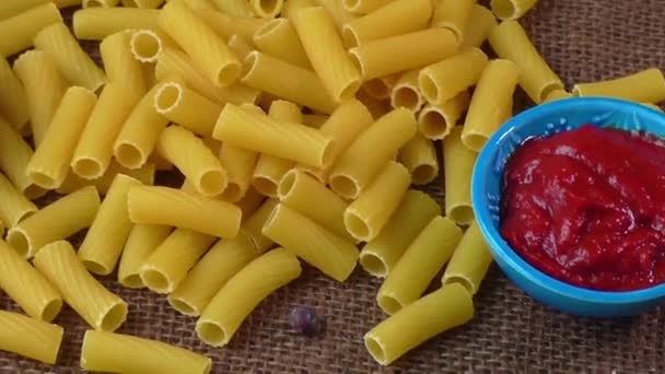 Pasta amarilla cruda, macarrones sobre fondo de saco — Vídeos de Stock